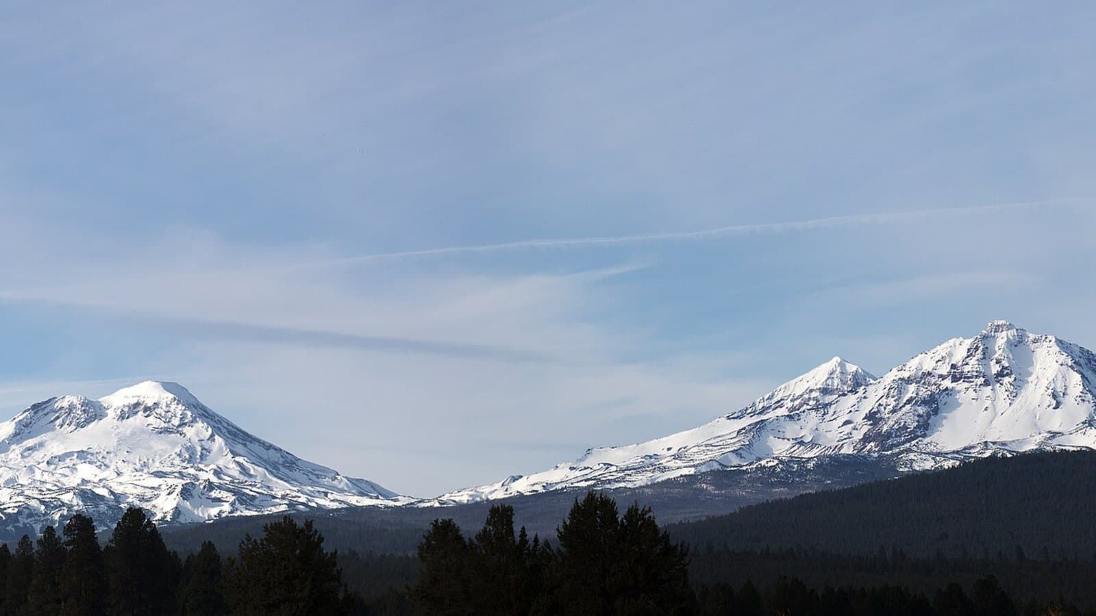 The Three Sisters peaks above the Central Oregon forest